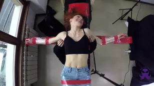 Dancer in pigtails and latex bound by an octopus dances for p