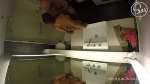 A blonde is fucking with a dark skinned man in the hotel bathroom shower